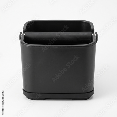 Black coffee knock box with rubber bar for barista espresso grounds disposal isolated on white