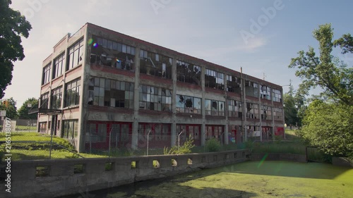 Wide shot of an abandoned building in an industrial zone (abandoned factory complex)