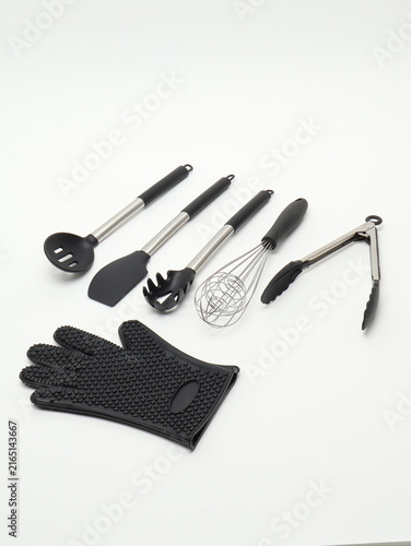 Fotografie Black silicone kitchen utensils set with heat resistant glove isolated on white