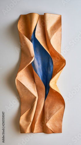 Soft, wavy material in warm copper tones
