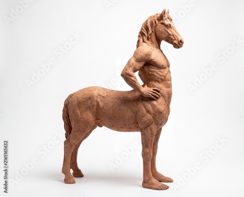 Surreal terracotta clay sculpture of a mythical hybrid creature with a horse head and human torso