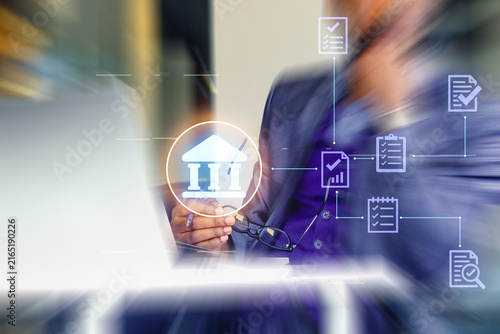 People working on banking tasks with digital elements in an office setting during the daytime