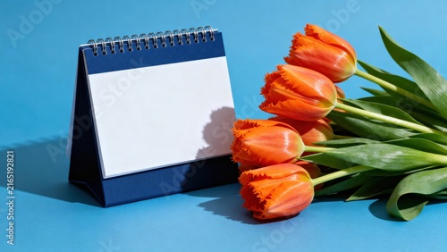 Blank Desk Calendar Mockup with Orange Tulips on Blue Background