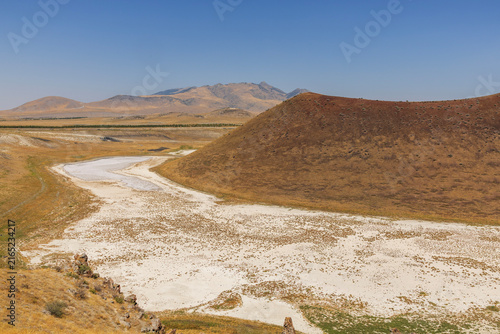 Bild auf Leinwand Aerial view of the dry landscape of Meke Lake, a volcanic crater lake in Karapinar, Konya, Turkey, surrounded by barren hills and salt-covered ground
