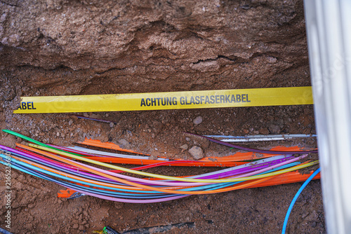 fiber optics – telecommunications cables are being laid in the ground at a construction site.