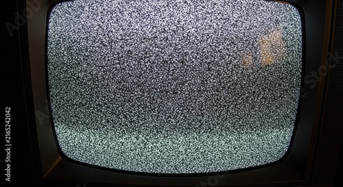 Vintage television set displaying static noise on its curved screen.