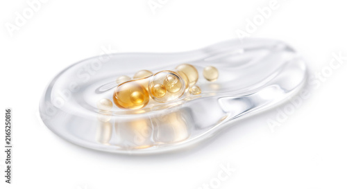 Side view of golden peptide spheres resting in high viscosity translucent serum gel