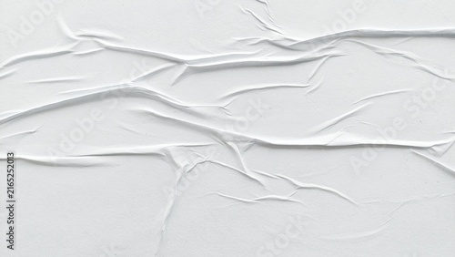 White crumpled and creased paper poster background with soft texture. Abstract blank white paper poster surface with wrinkled details. Crushed and soft white paper poster texture background.