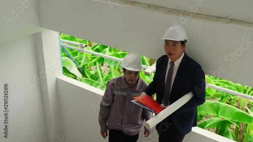 Construction inspector helmet blueprint folder safety teamwork discussion building architecture planning engineer professional site project collaboration industrial work development structure design