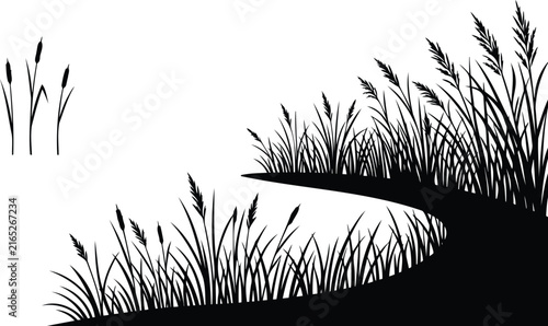 Black silhouette of reeds and wild grass by a river bank