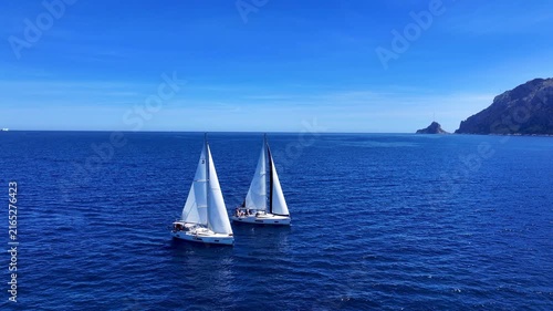 Aerial view of sailboats in turquoise sea at Tavolara island, Sardinia, Italy