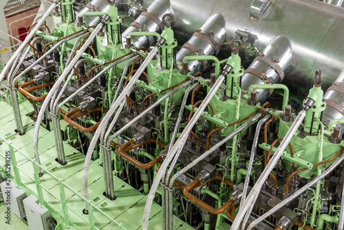Quadro su tela Top-down view of a large dual-fuel marine engine installed in the engine room of a commercial vessel, with the methanol fuel system and associated piping clearly visible around the engine