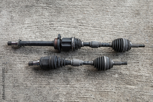 Close-up of front wheel drive car driveshafts ,car drive shaft repair and service in garage shop.	
 