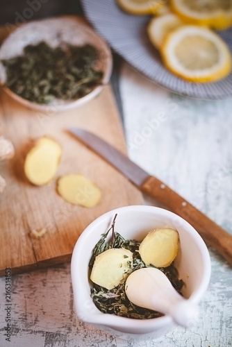 Preparing healthy peppermint and ginger tea in a mortar