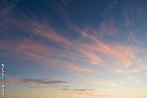 Aerial drone view of delicate soft pastel wispy clouds across colorful sunrise sky over Estonia, creating serene peaceful atmosphere background texture.