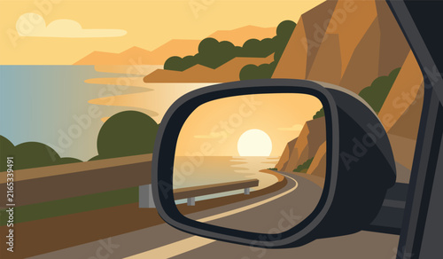 A coastal road reflected in a car's side mirror against the backdrop of a flat landscape at sunset.