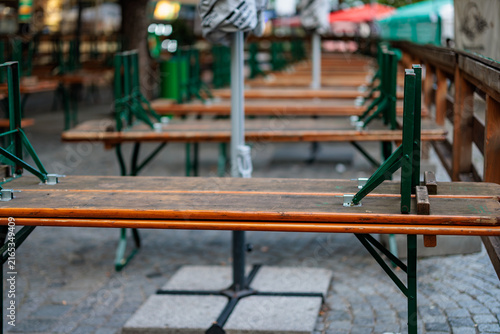 Empty wooden benches in a Munich outdoor seating area