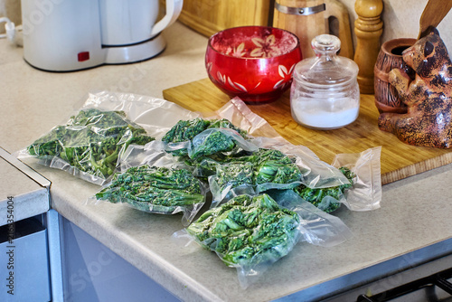 Freezing with vacuum packaging keeps broccoli portions neatly arranged on kitchen countertop, suggesting smart planning for homemade meals.