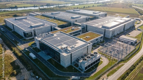 Aerial view of a large modern industrial logistics warehouse complex with solar panels.