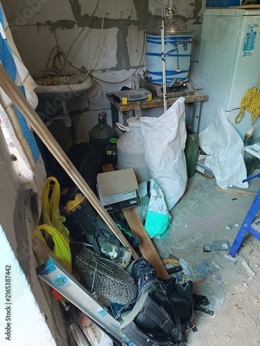Foto Messy garage corner with brewing and distillation equipment