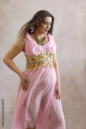 Serene Pregnant Woman in Pink Ancient Greek Toga - Maternity Portrait