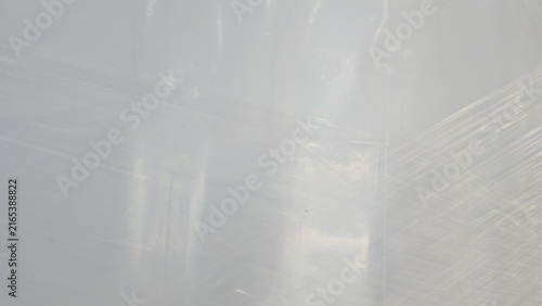 Transparent plastic wrapping film texture for logistics backdrop. Faded commercial plasticized wrap sheets for cargo shielding, displaying fine clean overlay lines.