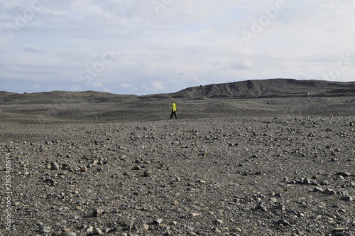 Human in a desert of black rock in Iceland