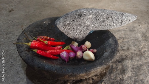 Obraz na płótnie Traditional Stone Mortar and Pestle with Fresh Chili and Spices