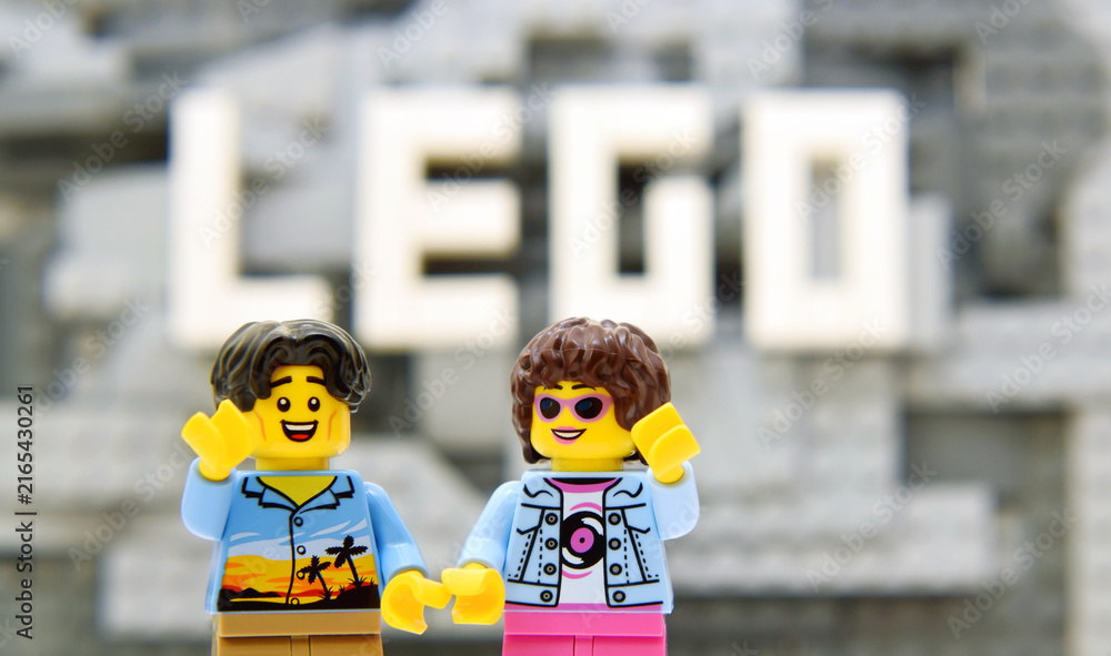 Fototapeta premium Lego minifigures are staying on mountain with word LEGO are builded from white bricks. Editorial illustrative image of popular brand of plastic bricks constructor.