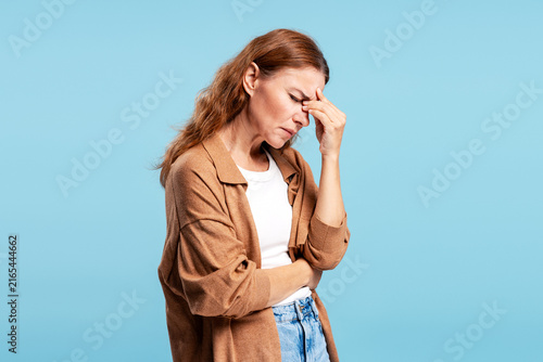 Принти на полотні Mature woman experiencing headache pain and stress