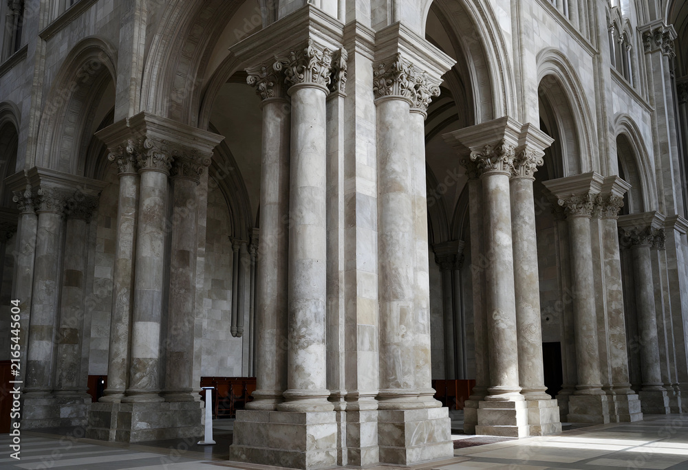 Fototapeta premium Ancient architecture and historical preservation, grand stone columns and arches inside a gothic cathedral interior