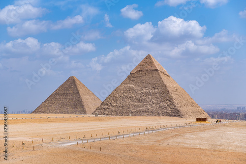 Fotografie Great Giza pyramids towering over the desert plateau, Khafre and Khufu, showcasi