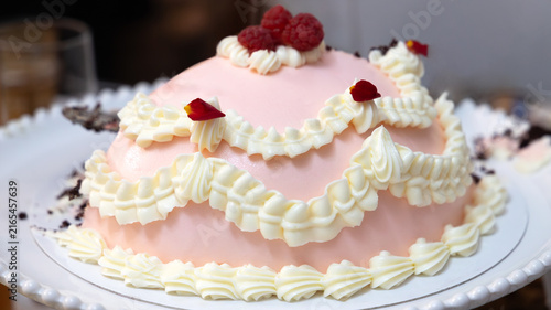 Pink Birthday Cake with White Piping and Fresh Raspberries Close-Up