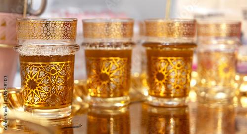 Row of Arabic-Style Tea Glasses on a Golden Tray