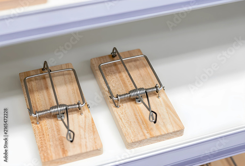 Risk and danger concept, two wooden mouse traps on a shelf, pest control and problem solving
