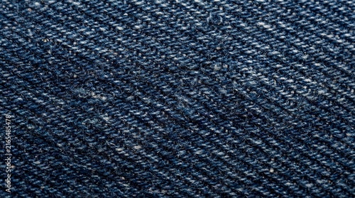 A close-up, detailed macro shot of blue denim fabric, showcasing its woven texture and diagonal pattern. The deep indigo color and slightly rough surface are clearly visible
