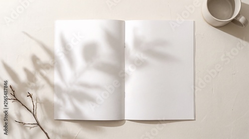Minimalist open blank notebook mockup with soft natural shadows