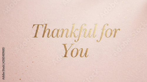 Thankful for you gold foil text on pink textured paper background with gratitude