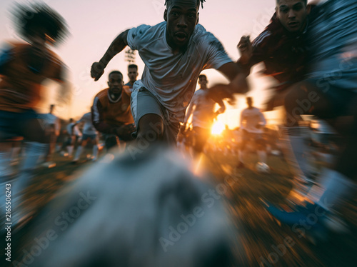 Dynamic Soccer Player Kicking Ball During Fast Match at Sunset