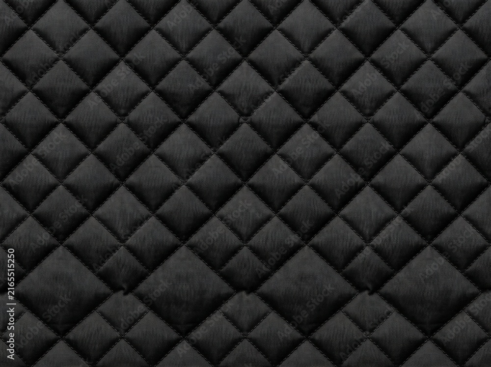 Fototapeta premium Abstract black quilted puffer fabric texture with diamond stitching pattern, ideal for jacket and textile backgrounds.