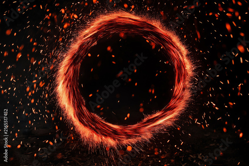 A dynamic circular pattern of glowing sparks against a dark background.