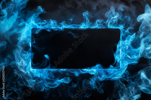 Abstract blue smoke encircles a central dark rectangle against a black backdrop.