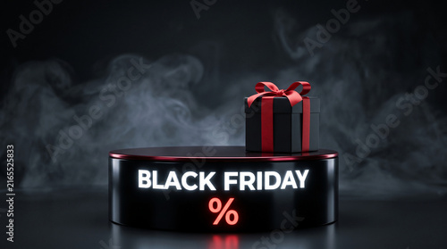 A black gift box with a red ribbon sits on a illuminated podium with 