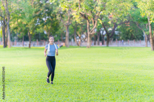 Obraz na plátně Young Asian woman in sportswear jogging and exercising outdoors in the park