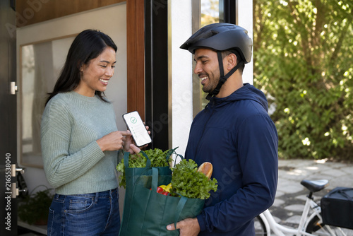 Customer Receiving an Online Grocery Delivery and Checking a Digital Receipt with a Bicycle Courier at the Front Door of a Modern Home