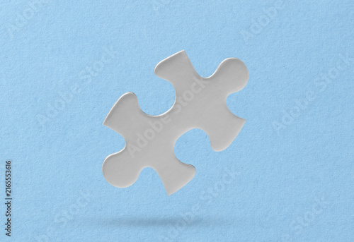 White puzzle piece on blue background