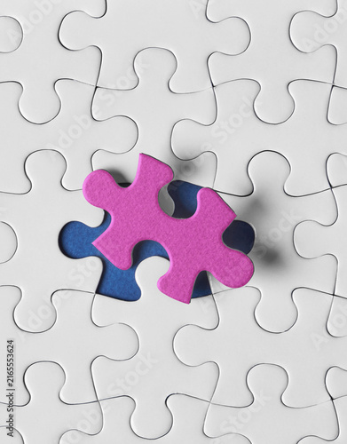Pink puzzle piece with blue missing piece