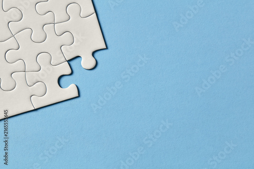 Puzzle corner on blue background with copy space