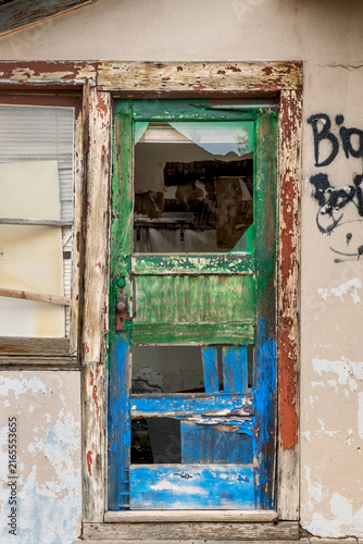 Old colorful, wooden door on side of house