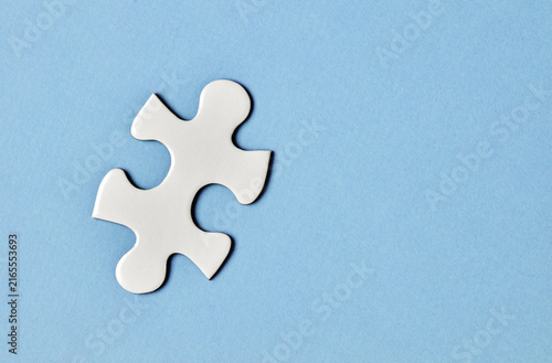 White puzzle piece on blue background